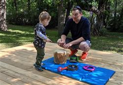 adult male and child playing outdoors